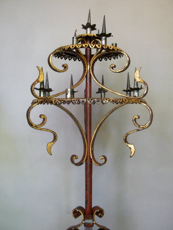 Three-tiered candleholders of painted and gilt wrought iron. Beautifully made.