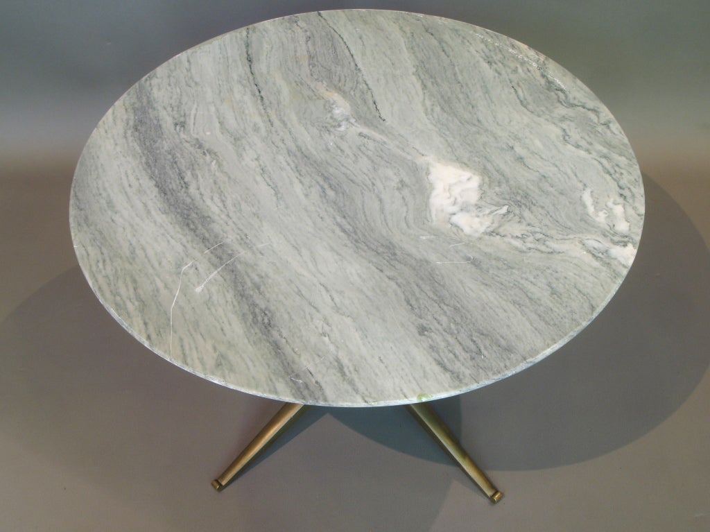 Small round coffee table. Veined marble top. Conical base of black painted wood and brass.
Very well made. Possibly by Gio Ponti.