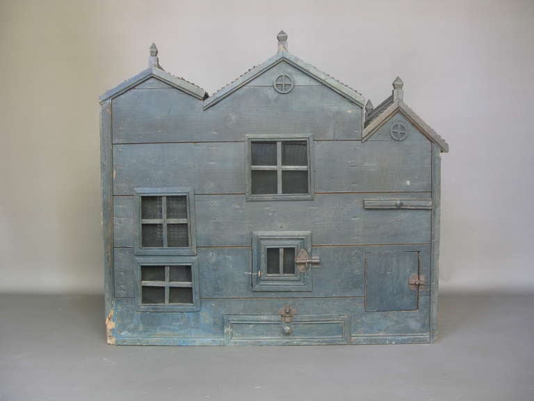 Hamster house, made of wood. Painted a blue-green on one front and side and bare wood on the other two sides. <br />
Very charming.
