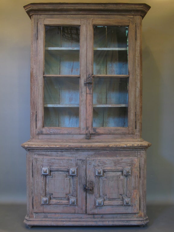 Charming vitrine/display cabinet in two sections painted in faded faux-bois on the outside and a bluey-grey on the inside. The top section has glass panes and the lower section two doors with diamond detail and faded polychrome paint.