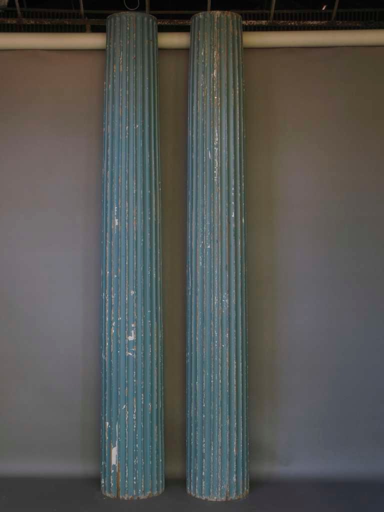 Stunning pair of very tall wood columns, hand carved and slightly tapering. Original blue-green paint.

One side is flat (see Photo 2).