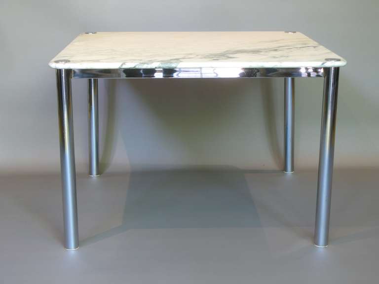 Square dining or centre tables with chromed iron bases and a marble tops with rounded edges. Four available.