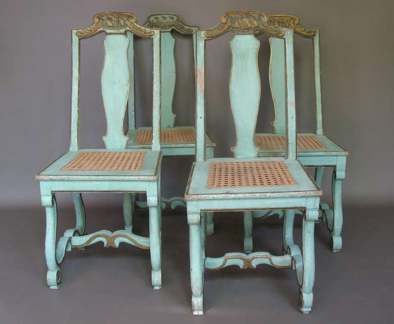 Four lovely Louis XIV style side chairs of carved wood, with beautiful original sea-green colour and details high-lighted in gold.  The crest rails are embellished with shell-like motifs. Exaggeratedly scrolling legs, joined by a central stretcher.