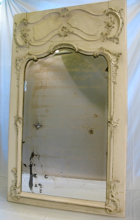 Impressive trumeau in original condition and with original mercury glass mirror. Beautifully carved 