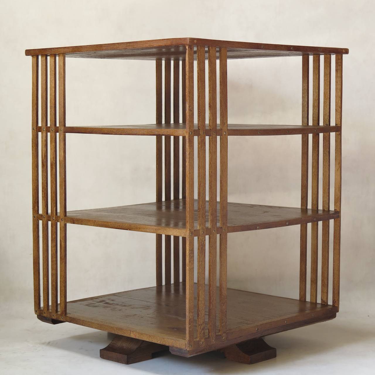 Minimalist chic rotating bookcase or shelves in varnished oak.