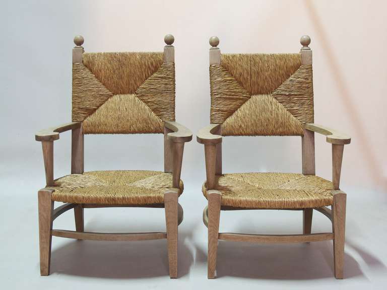 Very lovely pair of oak armchairs with low seats and shapely armrests. Wide and comfortable. Classic with a twist.