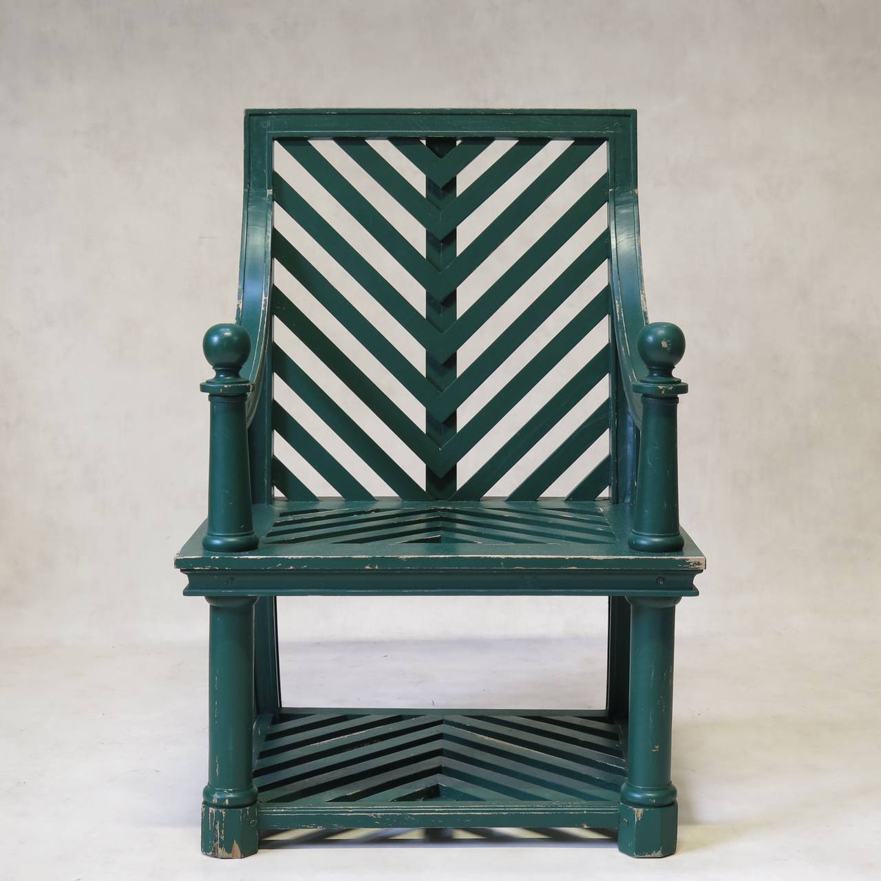 Wonderful pair of solid green-laquered garden chairs attributed to Emilio Terry. Herring-bone pattern; armrests ending topped with large spheres; cylindrical front legs ending in facteted feet; sabre back legs.