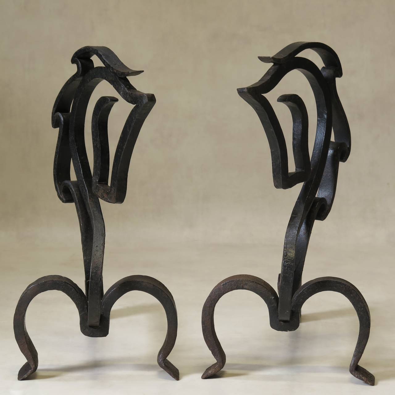 Wonderfully made and designed pair of forged iron andirons from the Camargue, in the South of France, representing supremely elegant horse head silhouettes.