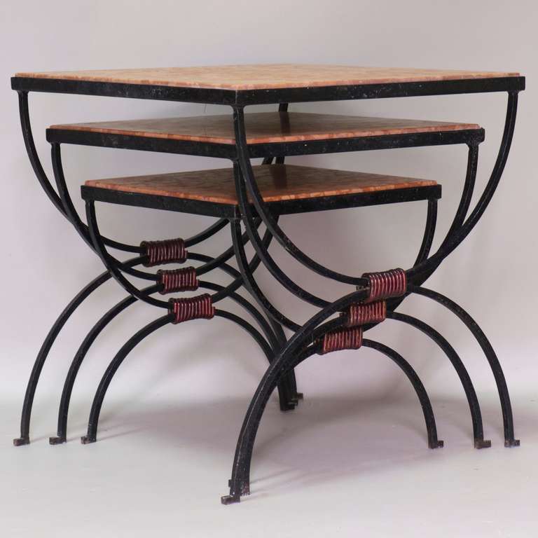 Fun set of three stacking tables with wrought-iron curule bases and red marble tops.

Dimensions provided below are for the largest table.