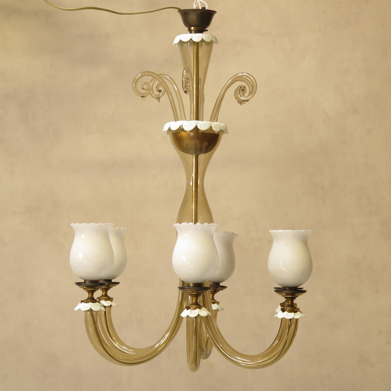 Elegant six-light venetian chandelier in amber-coloured glass, with milk glass bobeches and crimped decor.