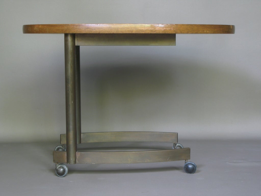 Very well-made table on casters. Elegant design.

Oval top with beautiful wood pattern.