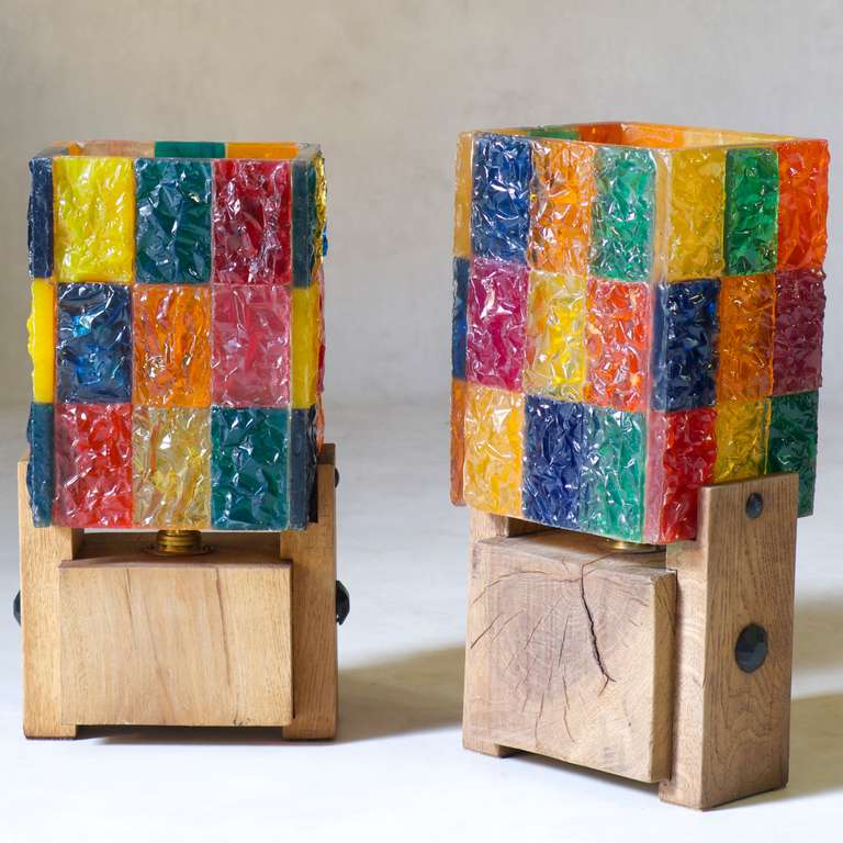 Fun and cheerful pair of tables lamps with colourful plastic resin shades with a translucent quality, and solid wood block bases.

Slight difference in the bases (one has a switch fixed to the base, the other on the electrical cord).

Look