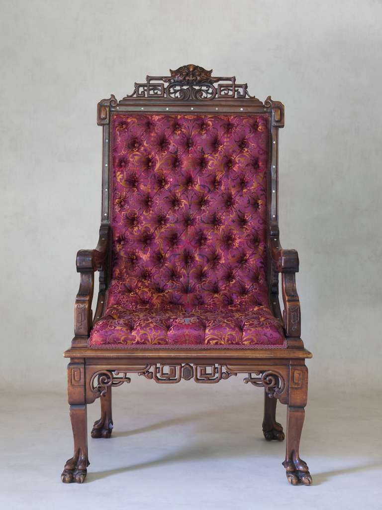 Impressive Asian-style armchair carved with fretwork detailing, mother-of-pearl inlays and  large carved lion's paw feet. 

Beautifully upholstered in 100% silk brocade with deep button tufting. The fabric is Tassinari & Chatel's Cernuschi