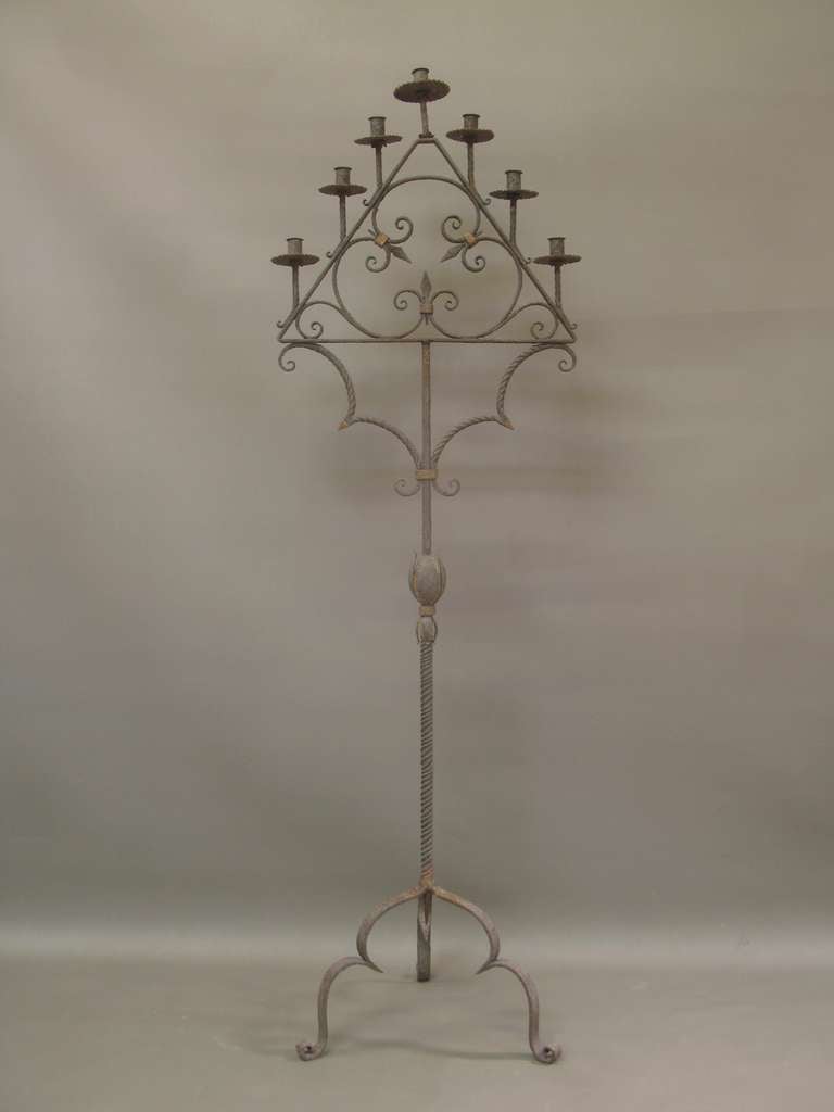 Pair of tall hand-wrought candelabras.  One was painted a long time ago (now a nice faded patina), the other was never painted. The difference is visible in photos 8 & 9.