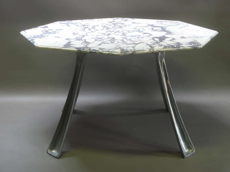 Dining table by French designer Michèle Charron and Atelier Charron, circa 1972. The base is of cast aluminum, and can be presented in two positions - either as seen in the photos, or upside-down, with the circle on the floor and the legs extending