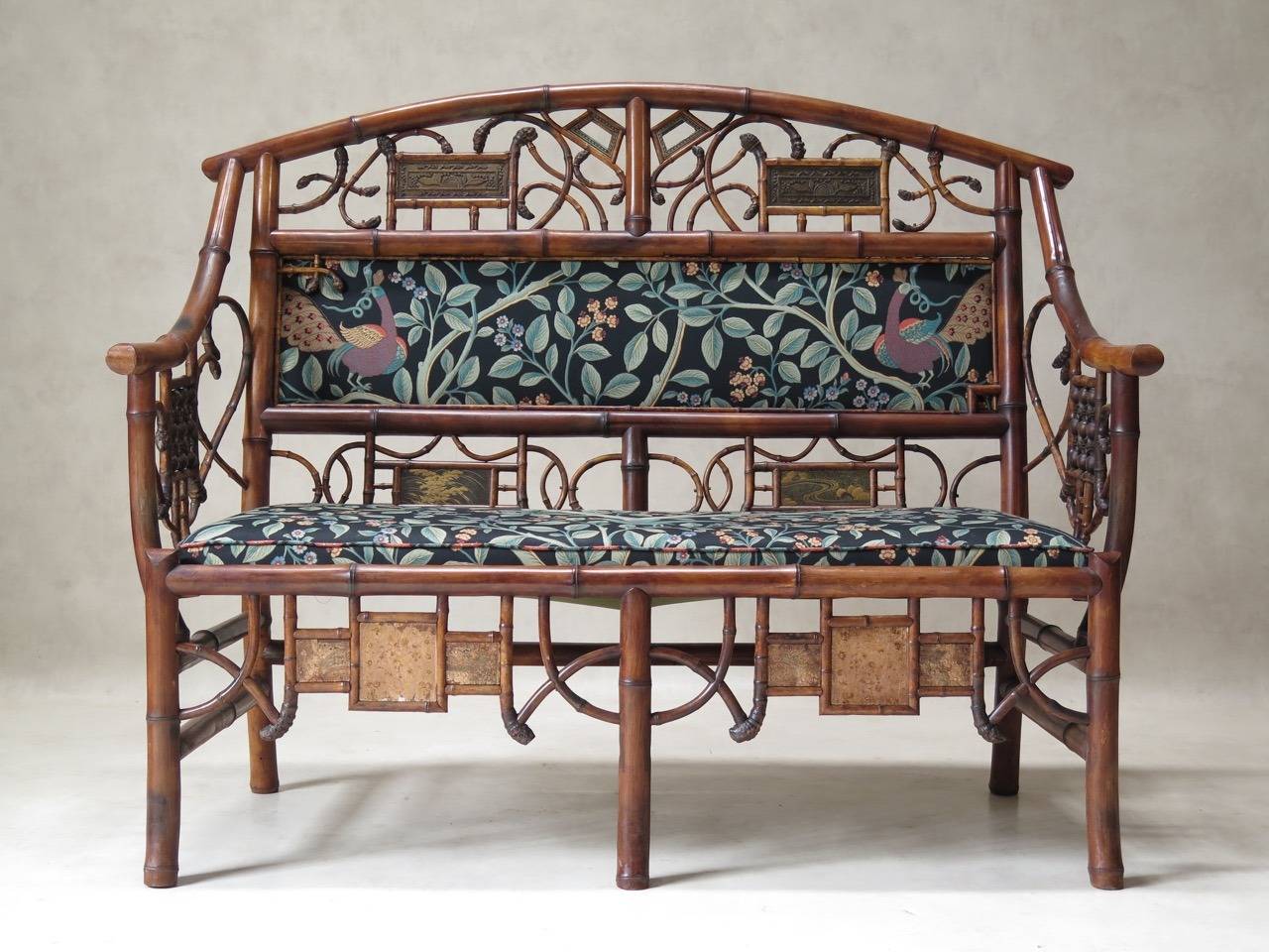 Charming and decorative bamboo living-room set comprised of a settee, two armchairs (not matching) and two high-backed chairs. Seats and backs newly upholstered in vintage fabric with a floral and bird motif on a dark background.

Dimensions