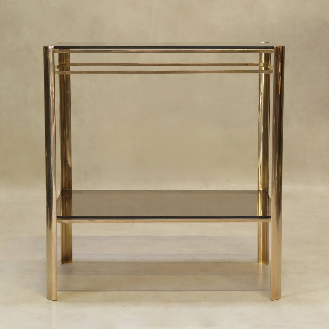 A bronze and glass two-tier side table by Jacques Quinet for the Maison Malabert.

Inset glass shelves. Manufacturer's mark engraved on the inside.