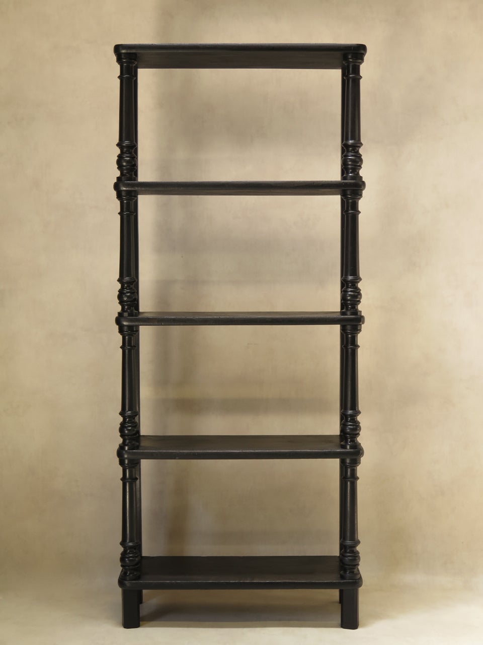 Elegant slender Napoleon III shelves in ebonized wood, with turned baluster front uprights, and rounded shelves. A nice classic piece.