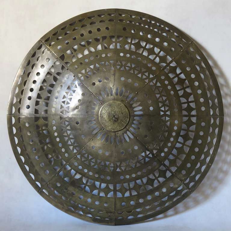 Wonderful round brass plafonnier with geometric cut-out patterns. The metal has acquired a nice polished patina.