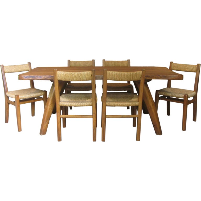 Beautifully crafted dining table and six chairs with rush seats and backs. Very well assembled. The table has a thick slab top with a soft, rounded uneven contour that follows the shape of the trunk. The veins in the wood are very lovely.

Chalet