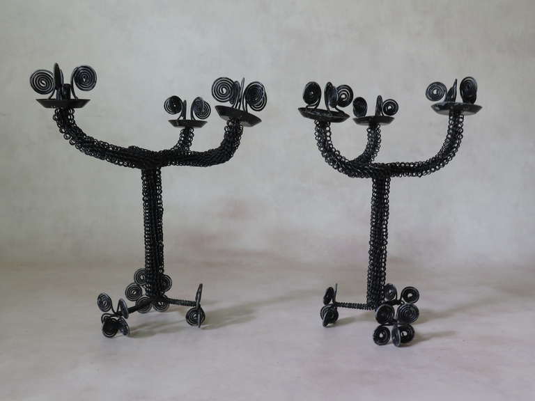 A delightful pair of one-of-a-kind Folk Art candleholders made of bent and braided wire, painted black.