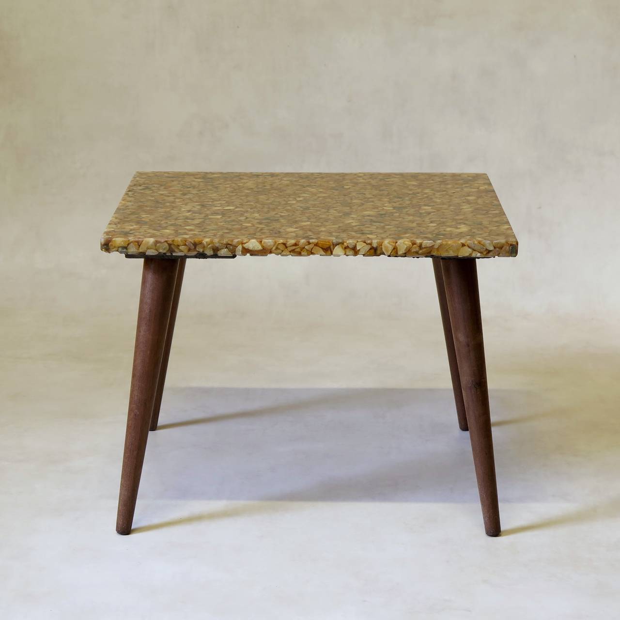 Unusual and wonderful pair of mid-century side tables with square tops made of small pebbles set in resin, raised on elegant and minimalist splayed and tapering legs.