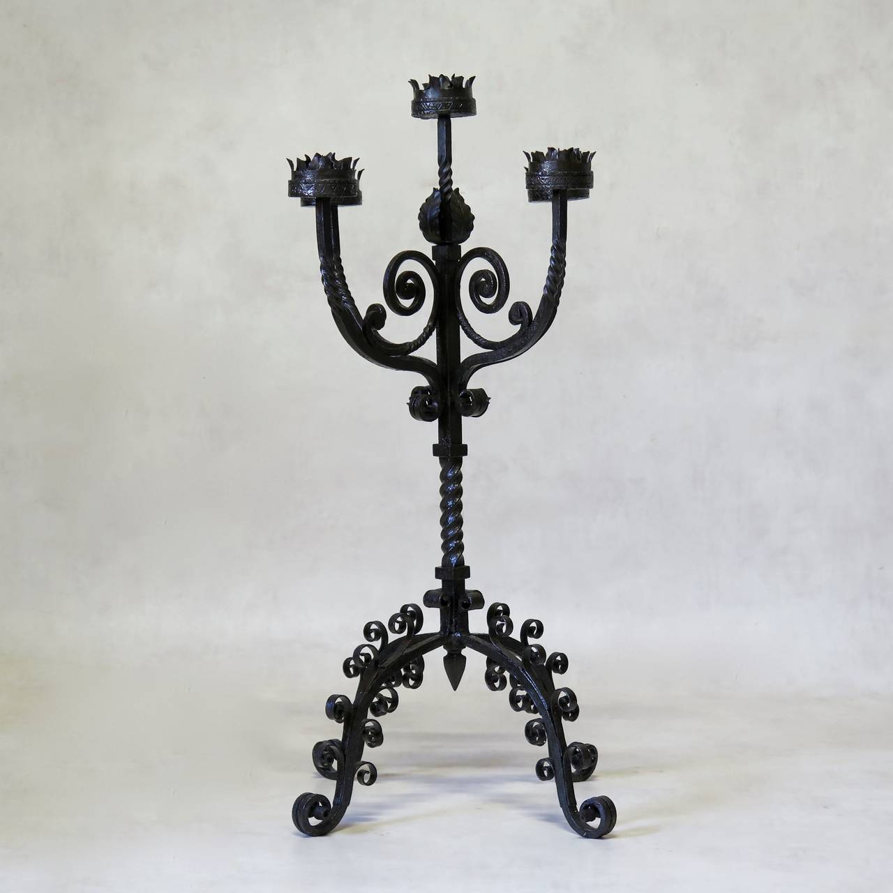 Ornate pair of wrought-iron candle holders. Lovely scrolling and patterned iron work.