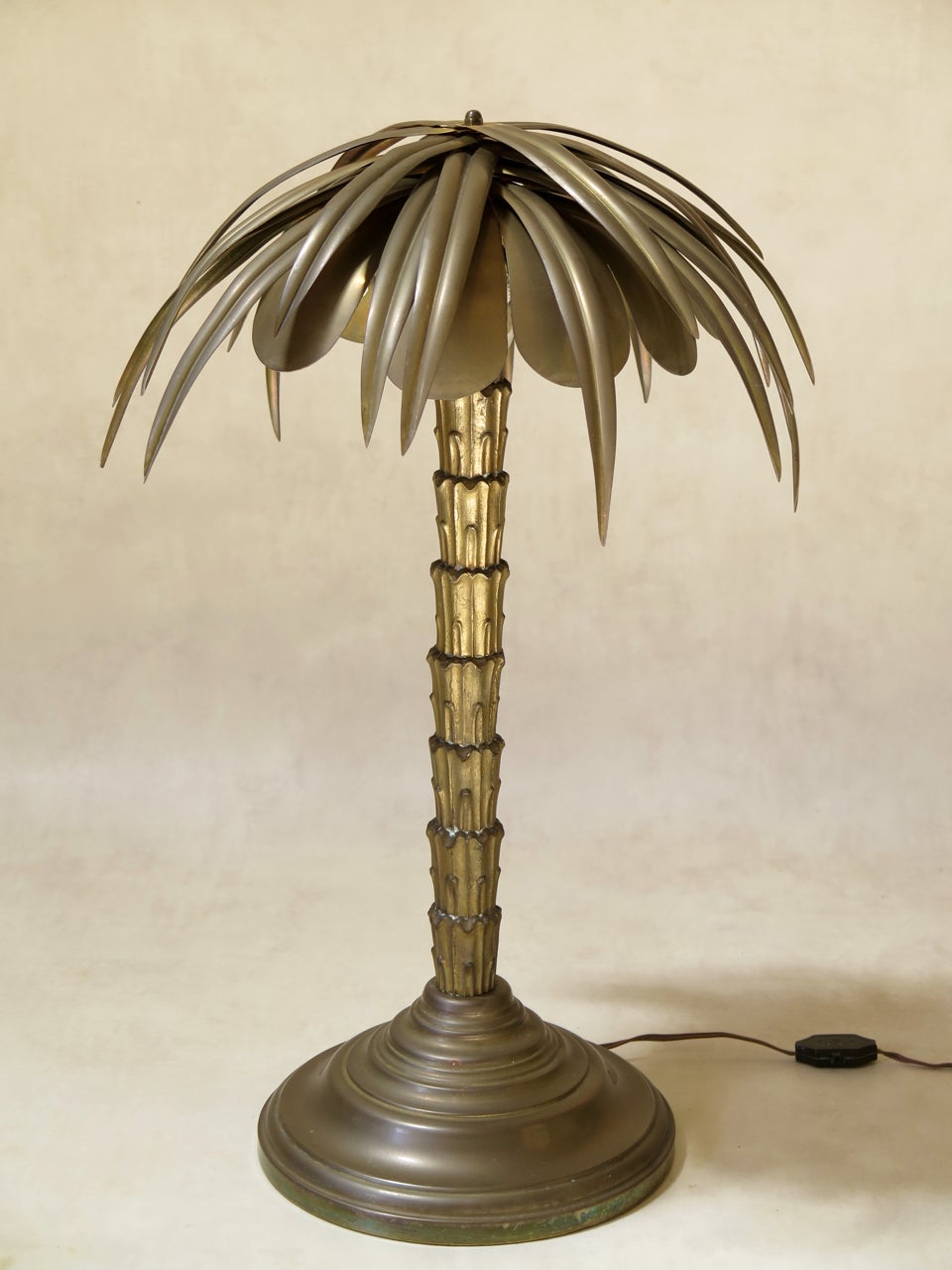 Handsome and well-made brass palm tree lamp. Each frond is an individual piece, and they are all fixed in place by a screw at the apex. The trunk is of solid cast brass, and is in two parts (top and bottom). Heavy round stepped base. Four original