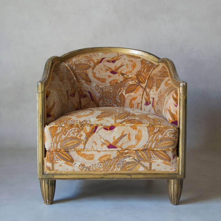 Splendido set Art Déco composto da due profonde poltrone con schienale a botte e un tavolino rotondo abbinato. 
Giltwood. Rivestito di recente in velluto d'epoca Art Deco, con un motivo floreale esotico e colibrì.
Anche il piano del tavolo è