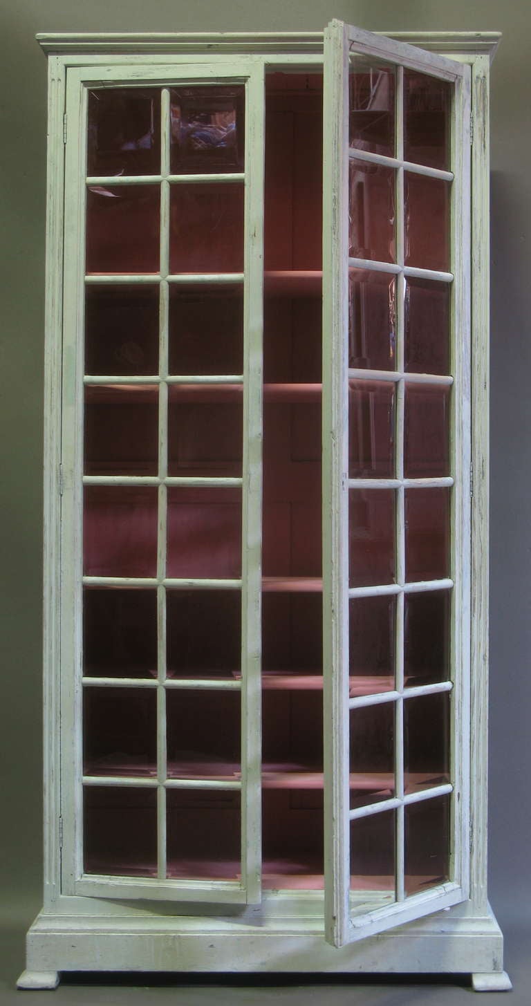 Small glass-fronted bookcase/ display cabinet, with all its original beveled glass panes. Off-white finish.