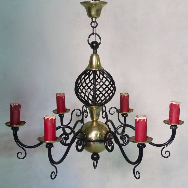 Six-light chandelier with a large iron sphere in the center and scrolling arms fixed to a large brass ball.