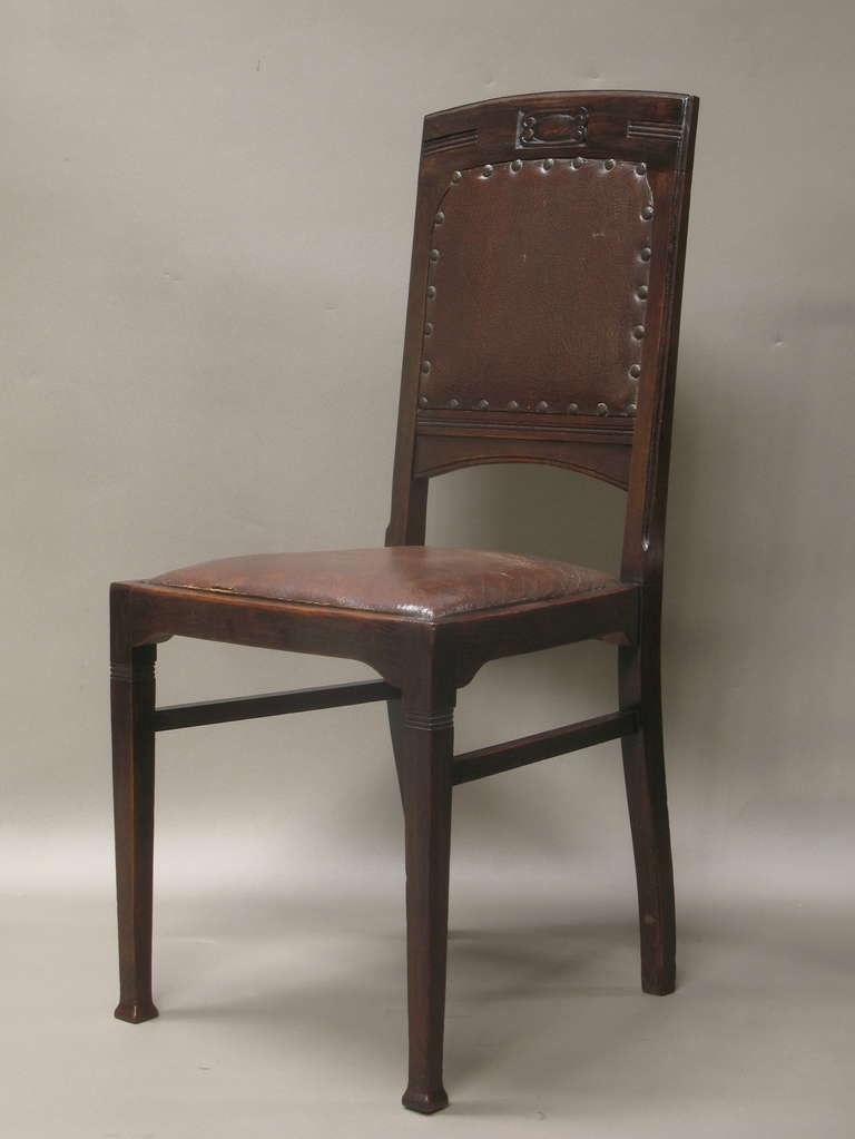 Set of six oak dining chairs from the Aesthetic Movement period.  Manufacturer's label still visible beneath one of the chairs, signed 