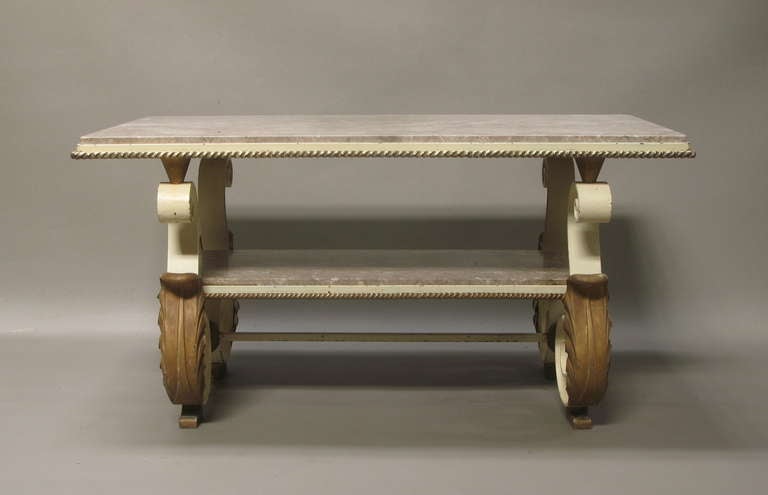 Very heavy and well-made low rectangular coffee table with two levels. Wrought iron structure, with original off-white and antique gold paint. Exaggerated scrolling legs with gilt metal acanthus leaf detail. The top section rests on four gilt