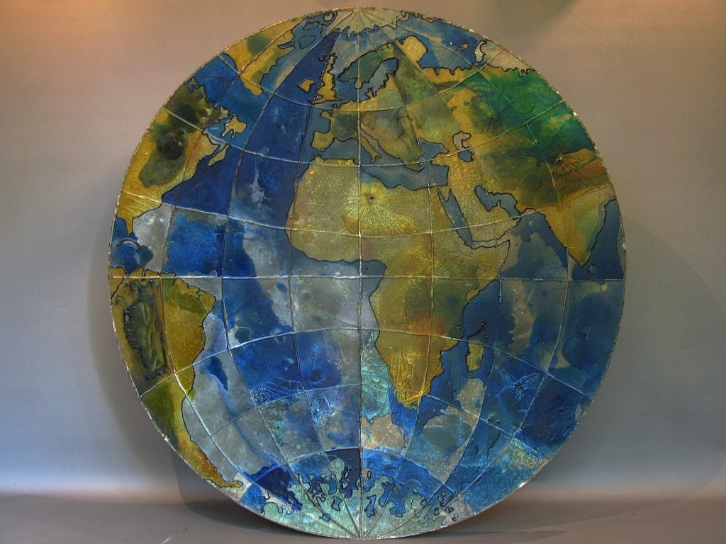 Fun, charming and enormous two-dimensional (disc-shaped) map of the world made of resin, of a translucent quality, which is especially when lit up from behind. 
It could easily be adapted into a light fixture (wall or ceiling), at the same time