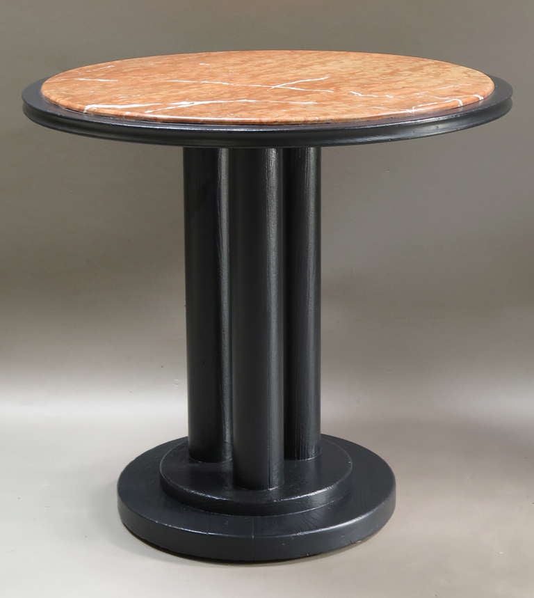 Elegant pair of round side tables. Late Art Deco period.

The tops are of red marble with white veins, supported by three round columns on a tiered round base.