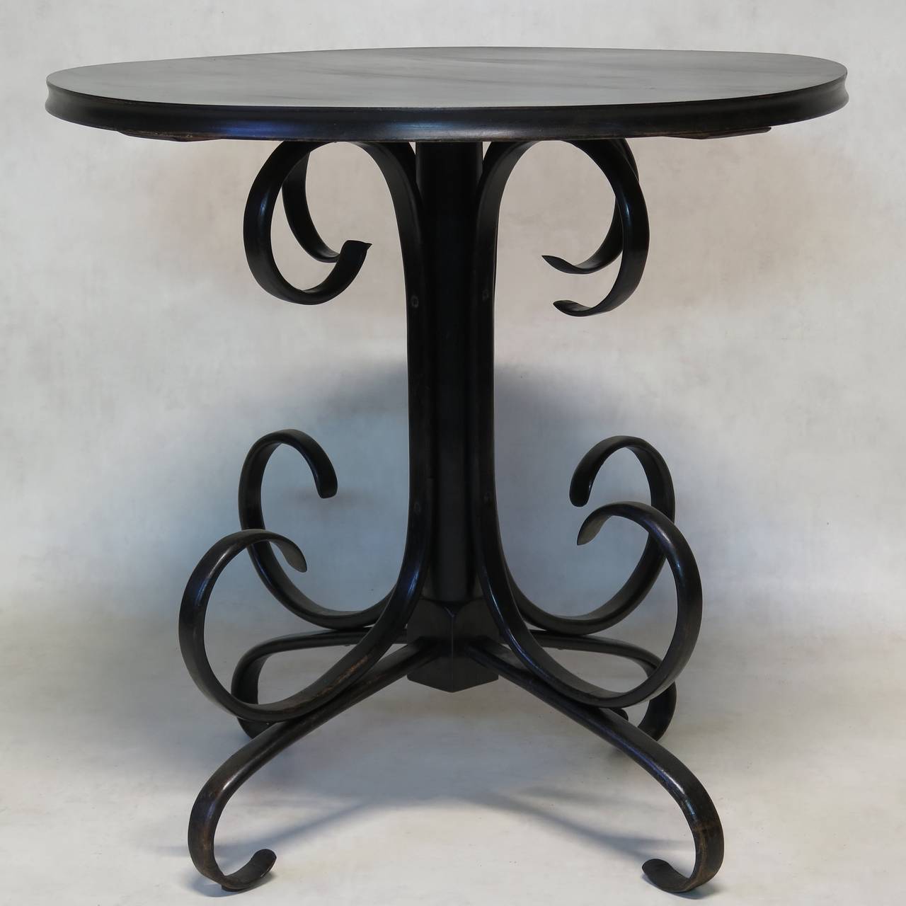 An elegant ebonised bentwood circular side table.