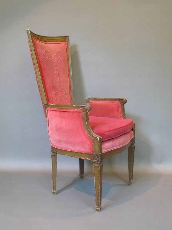 Charming and fun pair of armchairs with elegant curved high backs, upholstered in pink velvet with a stitched motif on the backs. Cut-out armrests with finial detail.