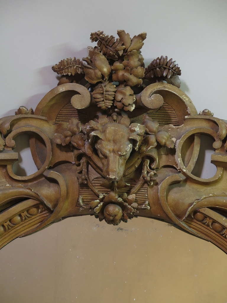 Amazing and rare mirror, from a French hunting lodge, elaborately carved in high relief.
At the apex, a foxhound head surrounded by ferns, oak leaves, acorns, autumn fruit and generous scrollwork.
At either side, two cornucopia horns.
Original