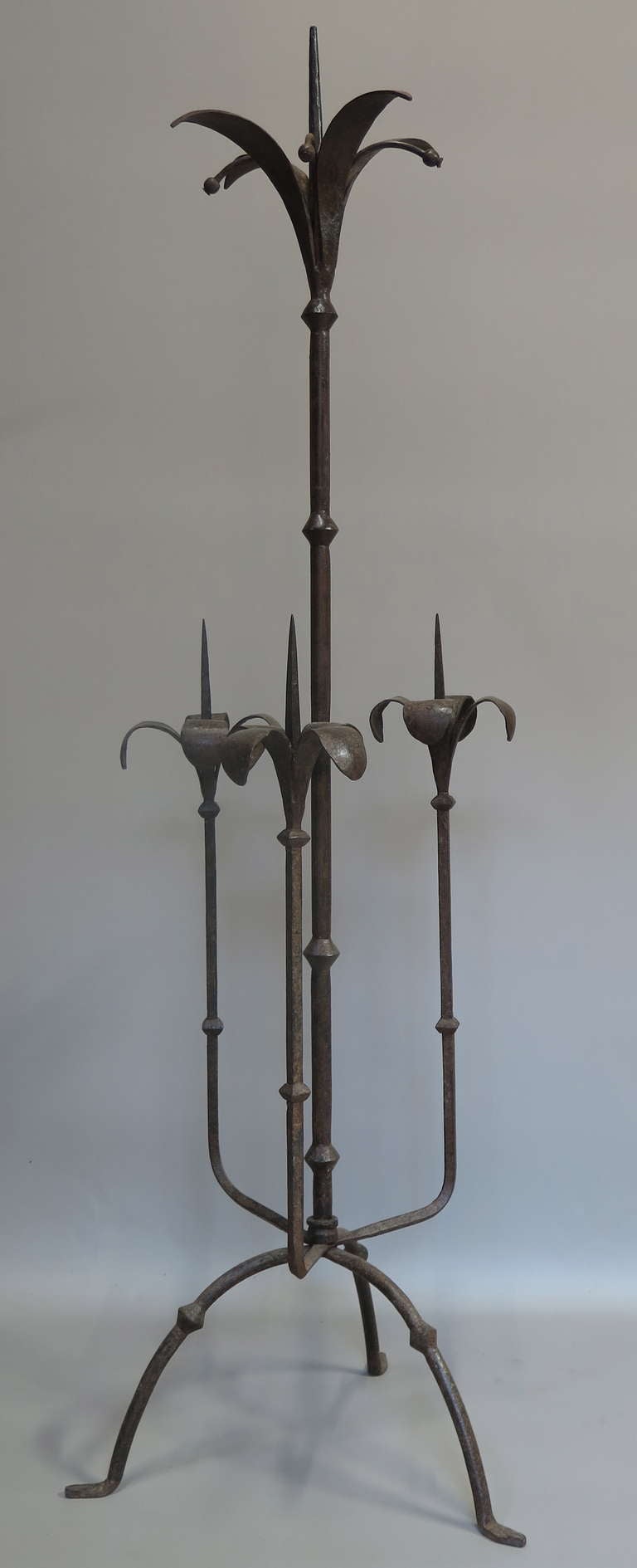 Hand-wrought iron candelabra with fleur-de-lys candle holders.
