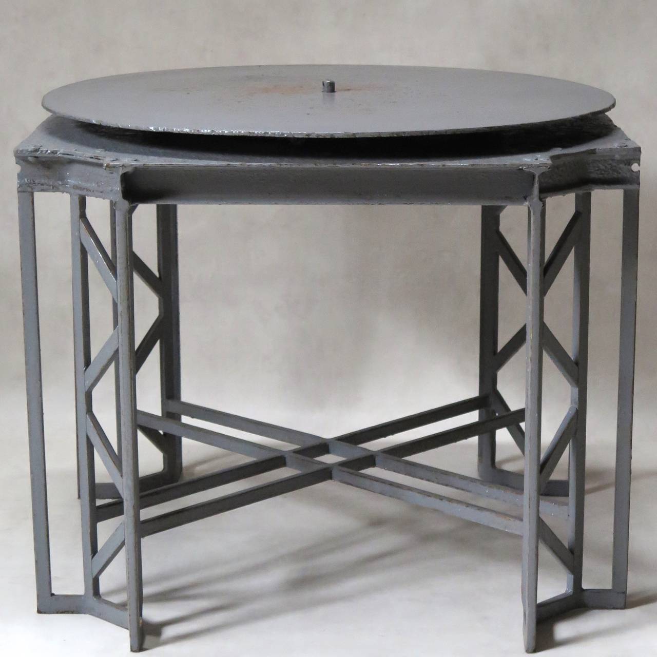A large and unusual wrought iron sculptor's stool, painted grey.