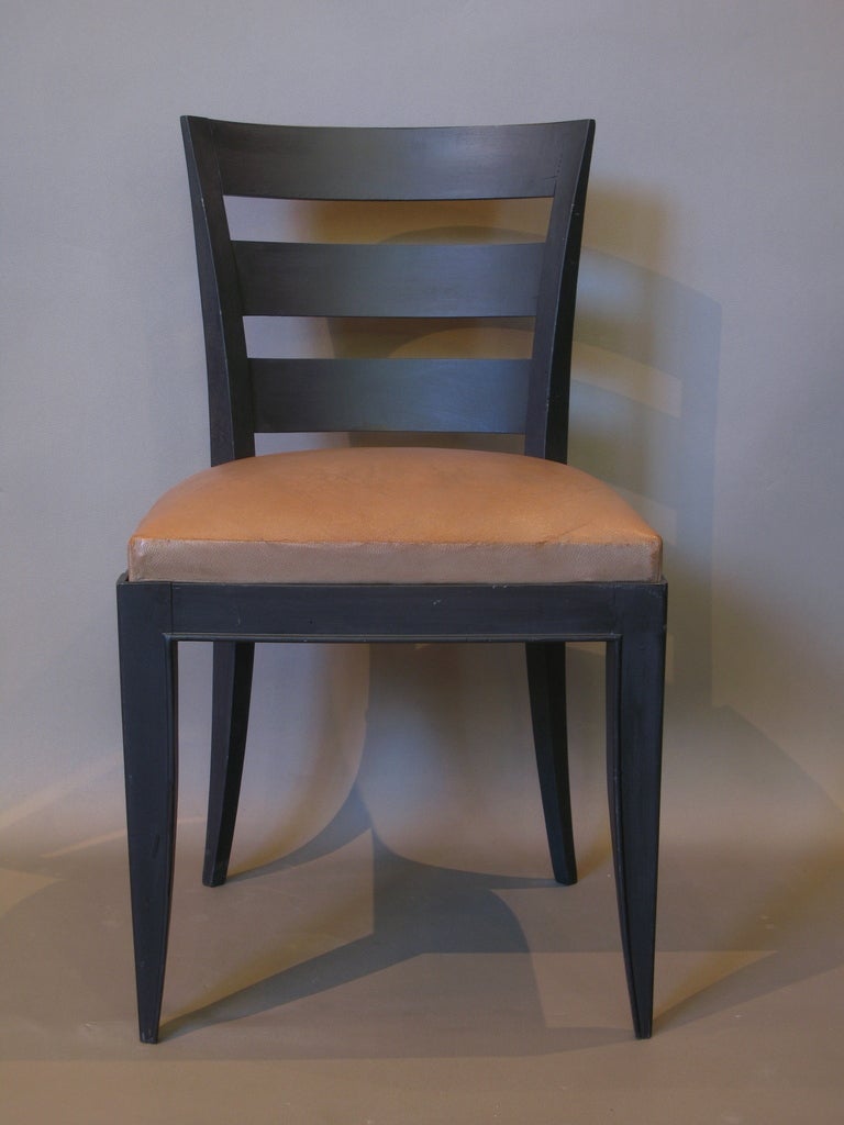 Six Art Deco dining chairs of crisp and graphic design. Curved backs, slightly splayed back legs and elegantly tapering front legs. Generous seats, upholstered in original (slightly weathered) tan leather.