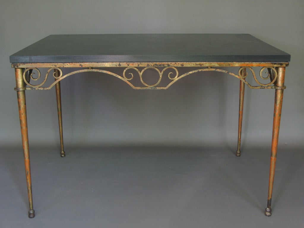 Beautiful iron console or center table. Original paint of red and orange primer showing through top gold colour.
Very elegantly designed apron. Discreetly tapering legs supported by double ball feet. 
Slate top.
Very elegant piece. Hand-made to
