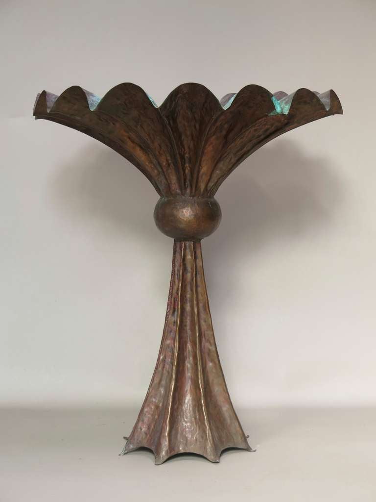 This unique piece is lovely in every respect: the finish of the hammered copper, the wonderful flared shape, the vibrant verdigris interior...

An unusual and striking piece. Very heavy.