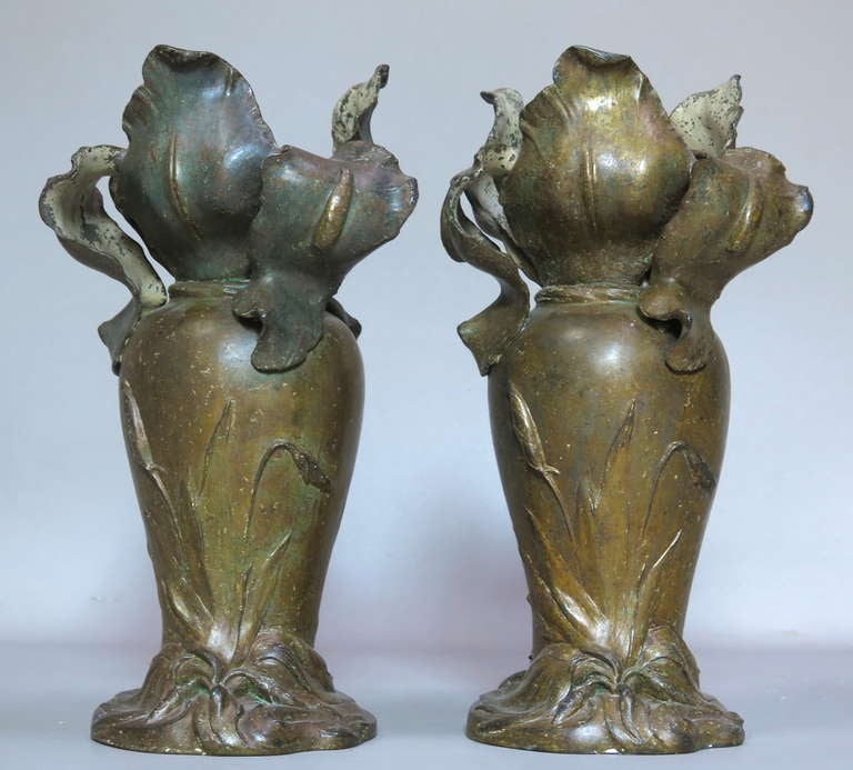 Lovely pair of cast metal vases from the Art Nouveau period, signed Van de Voorde on their bases. The top of the vases figures large irises. Lovely bronze-coloured patina.