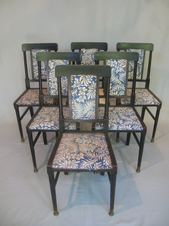 Handsome set of 6 dining chairs.

Very similar in design to chairs by British architect and furniture designer Edward William Godwin, made for Dromore Castle, circa 1877.

Center back panel flanked by two columns.

Brass sabots on front