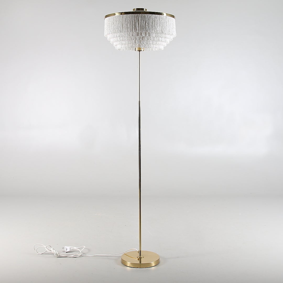 Floor lamp designed by Hans-Agne Jakobsson, Markaryd, Sweden, circa 1960s-1970s.
Brass shade with fringes. Measures: Height (140 cm), 55