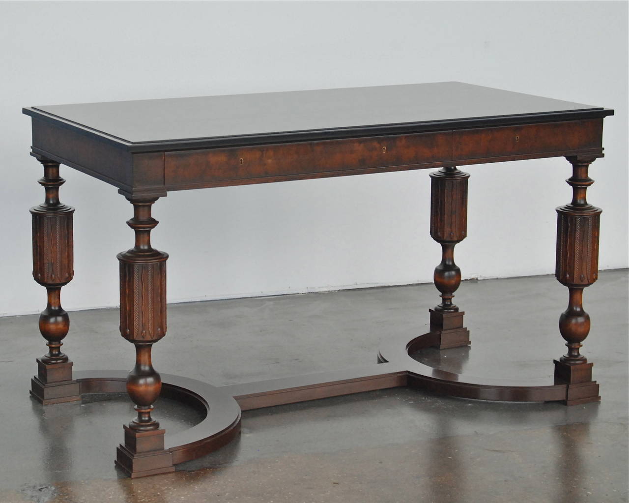 A desk or center table by Axel Einar Hjorth for Nordiska Kompanient, Sweden, circa 1930. The model Library, was designed in 1927 and presented at NK's exhibition in November 1928.
Stained wood with satin black tabletop. Three drawers. 
Label marked