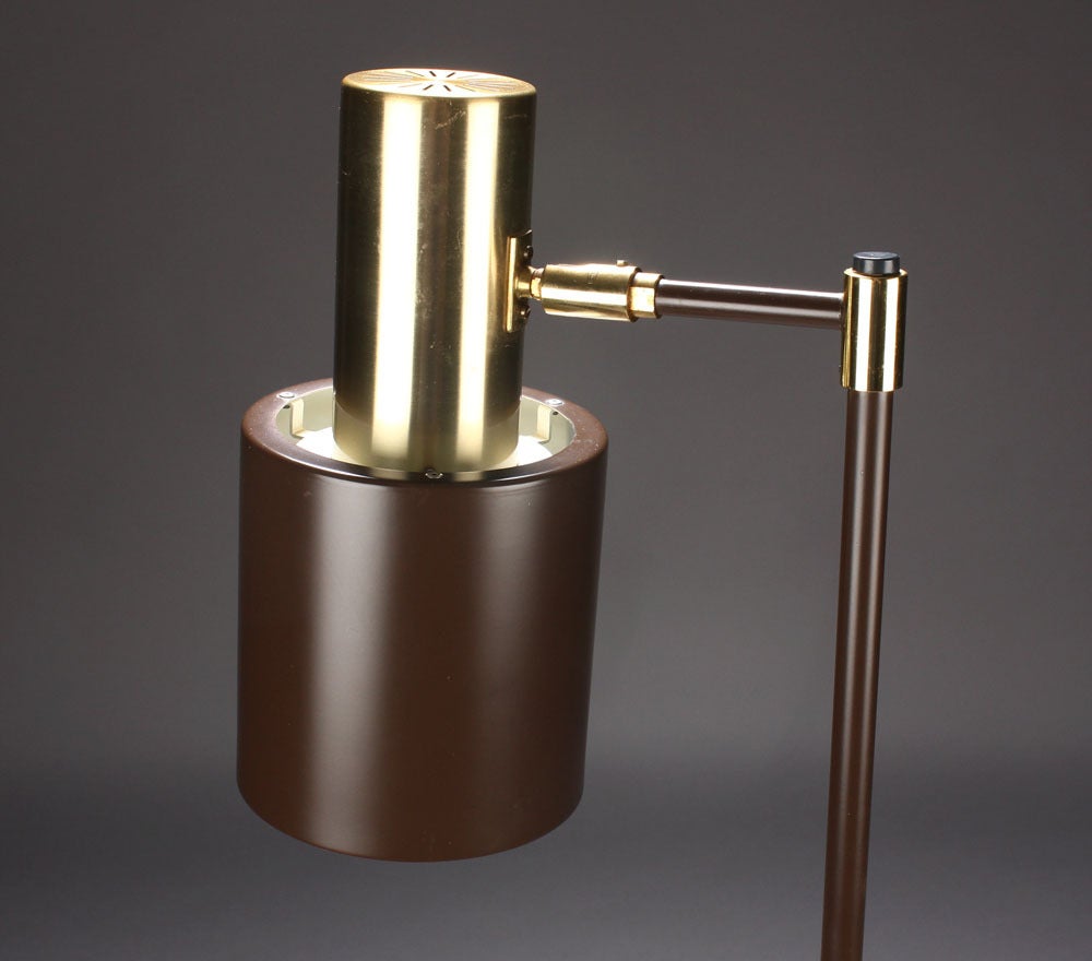 A floor lamp by Jo Hammerborg for Fog and Morup, Denmark, circa 1960s. Brown lacquered metal with brass accents. Adjustable shade. Height 57
