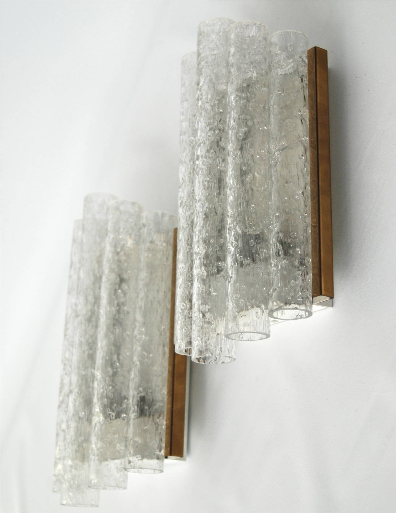 A pair of wall lights by Doria, Germany, circa 1960.
Textured glass tubes with brass trim.
Existing wiring, we do not guaranty functionality, rewiring available upon request. 
