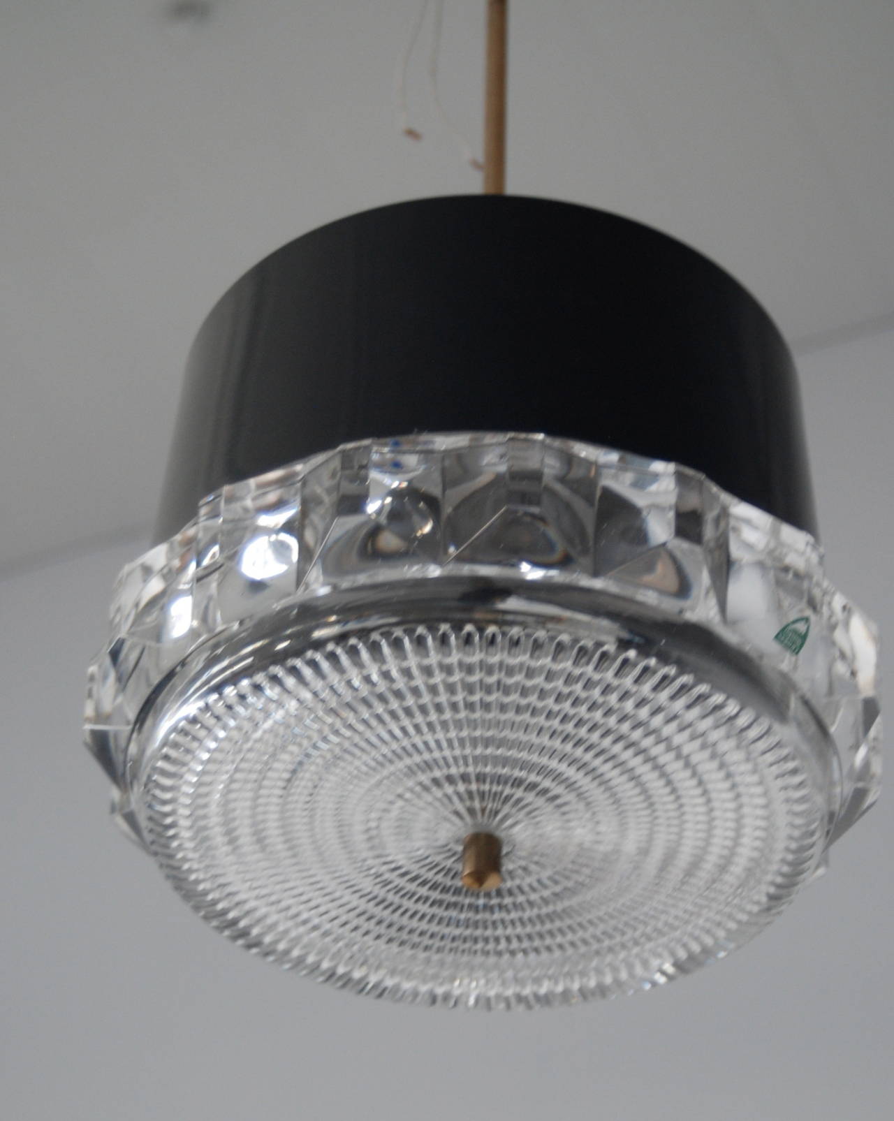 A pendant by Orrefors, Sweden, circa 1970.
Dark-grey lacquered aluminum shade withe glass decoration.
Marked Orrefors. Shade H - 8.5